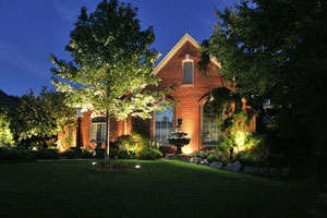 Exterior of a home illuminated by landscape lighting at night